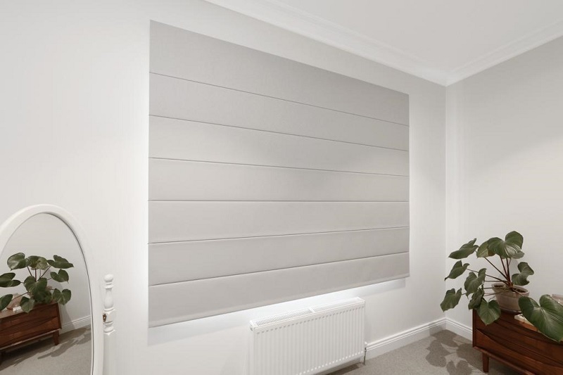 Grey Roman Blinds in closed position in dining room