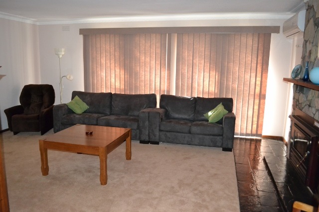 Lounge Room with Translucent Vertical Blinds with strong sunlight