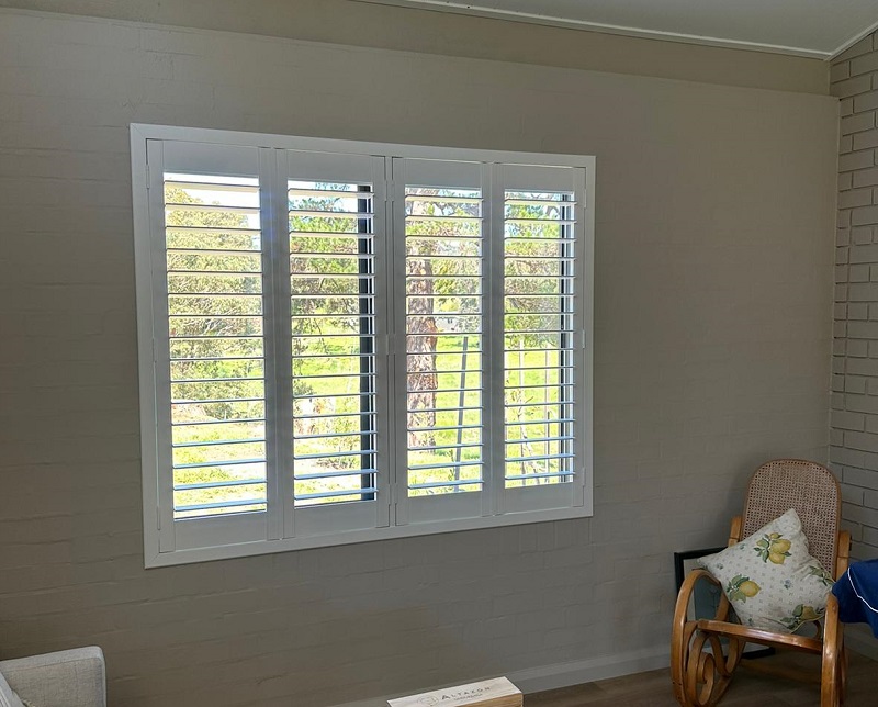 Timber Plantation shutters painted white installed in lounge room